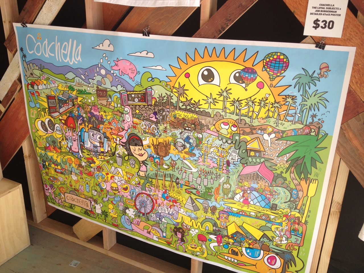 Coachella merch store 2012 — limited edition artist tees on display against chevron wood panels